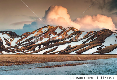 Landscape of volcanic mountain with snow covered and sunset sky among Icelandic Highlands on summer in Landmannalaugar at Iceland 101165494