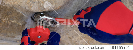 Wall faucet repair and plumber closeup. Plumbing services Wall faucet repair and plumber closeup. Plumbing services 101165505