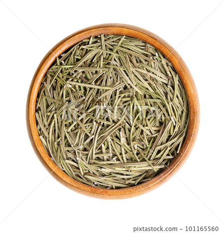 Dried rosemary leaves in a wooden bowl. Salvia rosmarinus, an aromatic and evergreen shrub, with fragrant and needle-like, green leaves, used as a medicinal and culinary herb. Close up, from above. 101165560