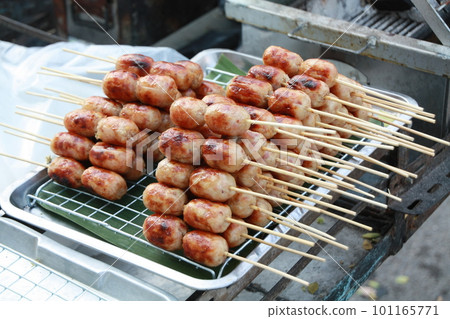 Isaan Sausage, a very popular street food in Thailand. Easy to buy, cheap price, delicious taste made from pork stuffed with sour seasoned rice and pork, served with ginger, fresh chilli, and lettuce. Isaan Sausage, a very popular street food in Thailand. Easy to buy, cheap price, delicious taste made from pork stuffed with sour seasoned rice and pork, served with ginger, fresh chilli, and lettuce. 101165771