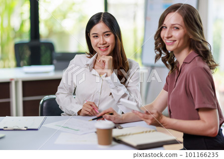 Concept of business office woman working, Businesswoman working with investment plan with her partner and analyzing document business investment graph data by using calculator and laptop Concept of business office woman working, Businesswoman working with investment plan with her partner and analyzing document business investment graph data by using calculator and laptop 101166235