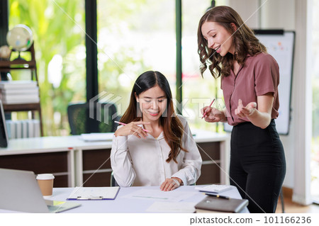 Concept of business office woman working, Businesswoman working with investment plan with her partner and analyzing document business investment graph data by using calculator and laptop Concept of business office woman working, Businesswoman working with investment plan with her partner and analyzing document business investment graph data by using calculator and laptop 101166236