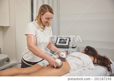 lifting body, Anti-cellulite, modern medical. Anti-cellulite roller-vacuum massage procedure is available in beauty salon to treat cellulite problem areas. Body care professional equipment 101167248