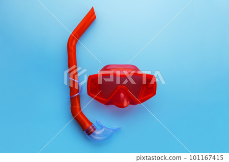 A set of red swimming mask and snorkel on a blue background 101167415