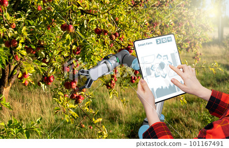 Farmer controls robotic arm with a tablet. 101167491