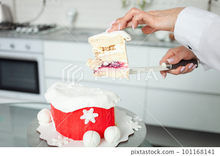 A confectioner cut cake, home production, unusual fillings, hobbies, business baking and selling sweets. white kitchen indoor 101168141