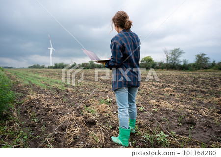 Farmer with laptop on the field. Farmer with laptop on the field. 101168280