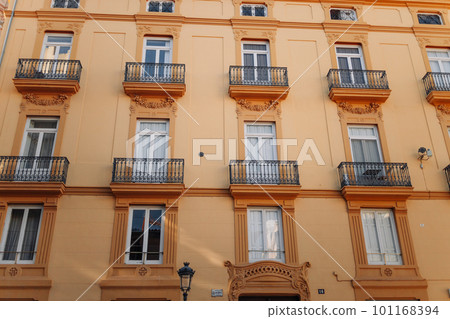 Windows with shutters and small balconies outside on the building facade downtown Barcelona, Spain Windows with shutters and small balconies outside on the building facade downtown Barcelona, Spain 101168394