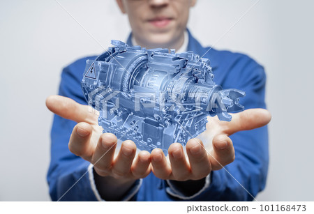 Development engineer holds in his hands a model of an electric transmission 101168473