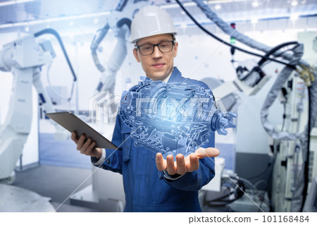 Development engineer holds in his hands a model of an electric transmission 101168484