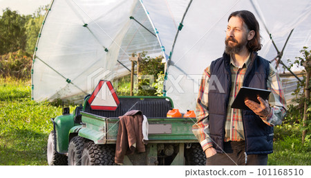 Farmer with digital tablet on an agricultural field. Farmer with digital tablet on an agricultural field. 101168510