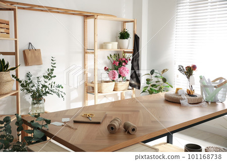 Florist's workplace with fresh flowers and wooden table 101168738