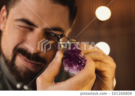 Jeweler working with gemstone on blurred background, closeup Jeweler working with gemstone on blurred background, closeup 101168809