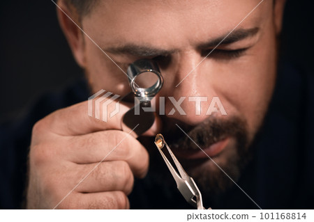 Professional jeweler working with gemstone, closeup view 101168814