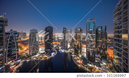Tall residential buildings at JLT aerial day to night timelapse, part of the Dubai multi commodities centre mixed-use district. 101168997