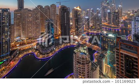 View of various skyscrapers in tallest recidential block in Dubai Marina aerial day to night timelapse 101169025