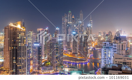 View of various skyscrapers in tallest recidential block in Dubai Marina aerial day to night timelapse 101169031