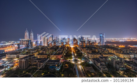 Panorama of skyscrapers in Barsha Heights district and low rise buildings in Greens district aerial all night timelapse. 101169134