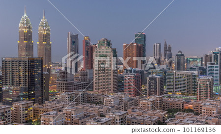 Skyscrapers in Barsha Heights district and low rise buildings in Greens district aerial day to night timelapse. Skyscrapers in Barsha Heights district and low rise buildings in Greens district aerial day to night timelapse. 101169136
