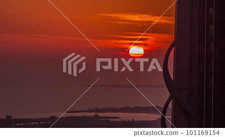 Sunset over sea near Dubai water canal with orange sky aerial timelapse. 101169154