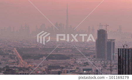 Dubai Downtown skyline row of skyscrapers with tallset tower aerial night to day timelapse. UAE 101169279