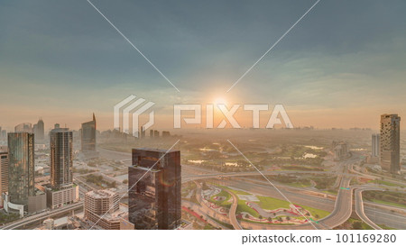 Sunrise over highway junction near media city and al barsha heights district area timelapse from Dubai marina. 101169280