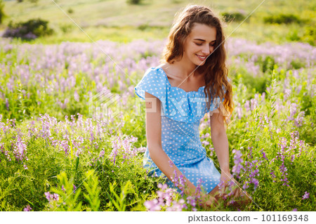 Portrait of beautiful woman in amazing in a blooming field. Nature, vacation, relax and lifestyle. Portrait of beautiful woman in amazing in a blooming field. Nature, vacation, relax and lifestyle. 101169348