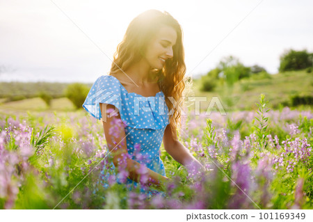 Portrait of beautiful woman in amazing in a blooming field. Nature, vacation, relax and lifestyle. 101169349