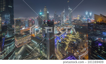 Panorama of futuristic skyscrapers after sunset in financial district business center in Dubai day to night timelapse 101169409