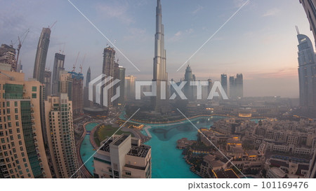 Aerial view of Dubai city early morning during fog night to day timelapse. 101169476