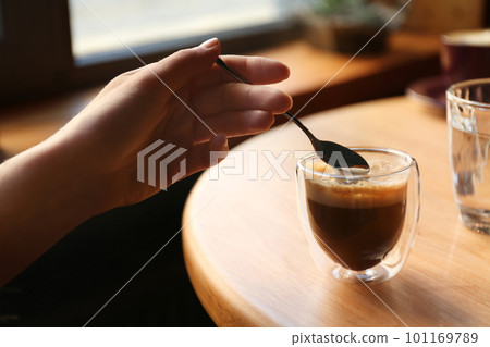 Woman with aromatic coffee at table in cafe, closeup 101169789