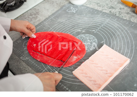 pastry chef makes mastic to decorate cake. Elastic dough, delicious pastries, cooking process. Home production, hobbies, entrepreneurship. knitted lace 101170062