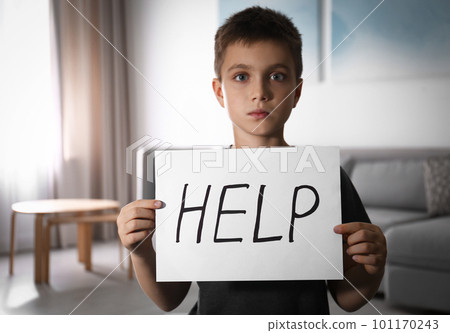 Abused little boy with sign HELP indoors. Domestic violence concept 101170243