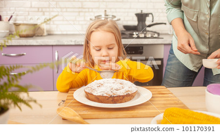 Portrait of little girl of three years old, kitchen, pie, dabbling, funny. decorates the cake. Portrait of little girl of three years old, kitchen, pie, dabbling, funny. decorates the cake. 101170391