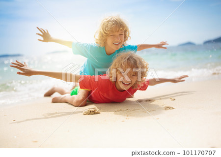 Kids on tropical beach. Children playing at sea. 101170707