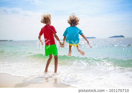 Kids on tropical beach. Children playing at sea. Kids on tropical beach. Children playing at sea. 101170710