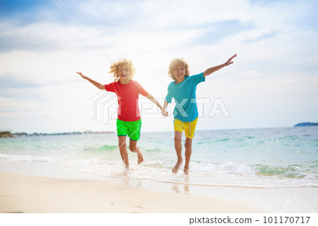 Kids on tropical beach. Children playing at sea. 101170717