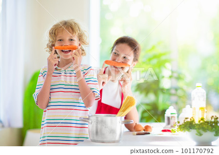 Family cooking dinner Mom and child cook spaghetti 101170792