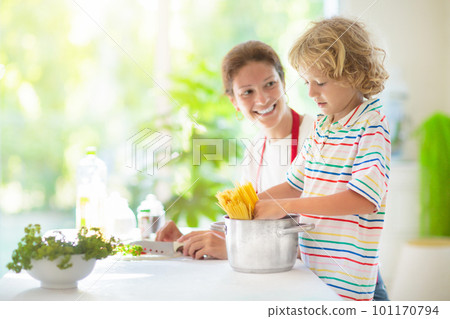 Family cooking dinner Mom and child cook spaghetti 101170794