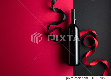 Bottle of red wine with satin ribbons. Bottle of red wine with satin ribbons. 101170883