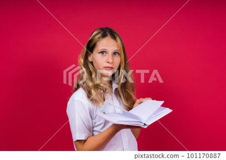 Child making notes. Kids dreams.Isolated on red background. Education, Kid back to school. Child making notes. Kids dreams.Isolated on red background. Education, Kid back to school. 101170887