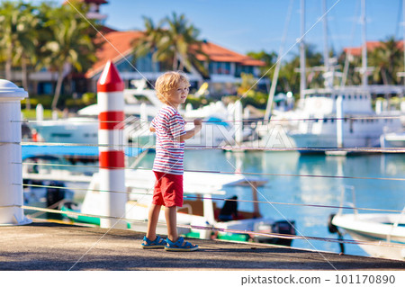 Child watching yacht and boat in harbor. Yachting. Child watching yacht and boat in harbor. Yachting. 101170890