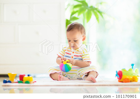 Baby boy playing with toy Baby boy playing with toy 101170901