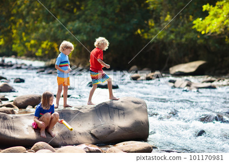 Child hiking in mountains. Kids at river shore. 101170981