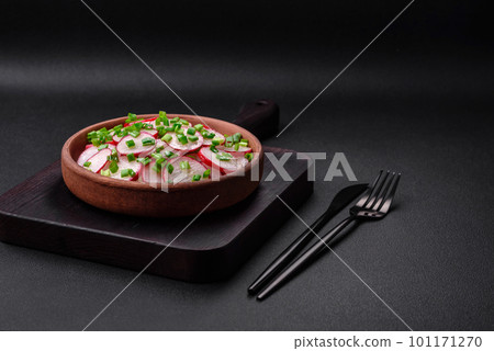 Delicious fresh salad of sliced ??radishes with green onions, salt and olive oil 101171270
