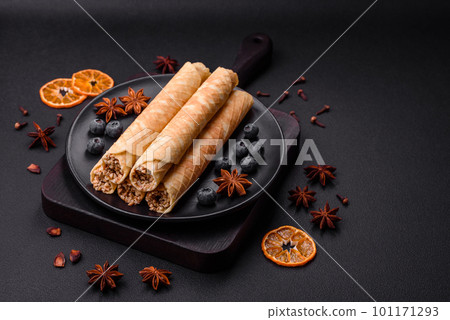 Delicious crispy wafer rolls with cream filling with nuts Delicious crispy wafer rolls with cream filling with nuts 101171293