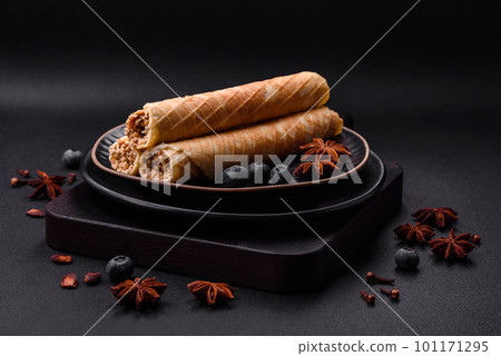 Delicious crispy wafer rolls with cream filling with nuts Delicious crispy wafer rolls with cream filling with nuts 101171295
