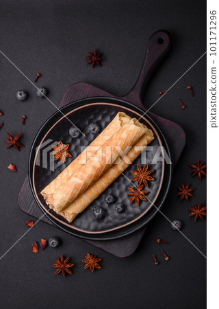 Delicious crispy wafer rolls with cream filling with nuts Delicious crispy wafer rolls with cream filling with nuts 101171296