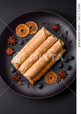 Delicious crispy wafer rolls with cream filling with nuts Delicious crispy wafer rolls with cream filling with nuts 101171304