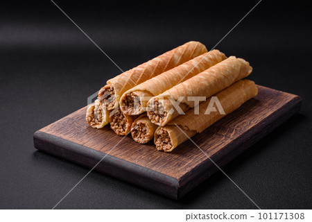 Delicious crispy wafer rolls with cream filling with nuts Delicious crispy wafer rolls with cream filling with nuts 101171308